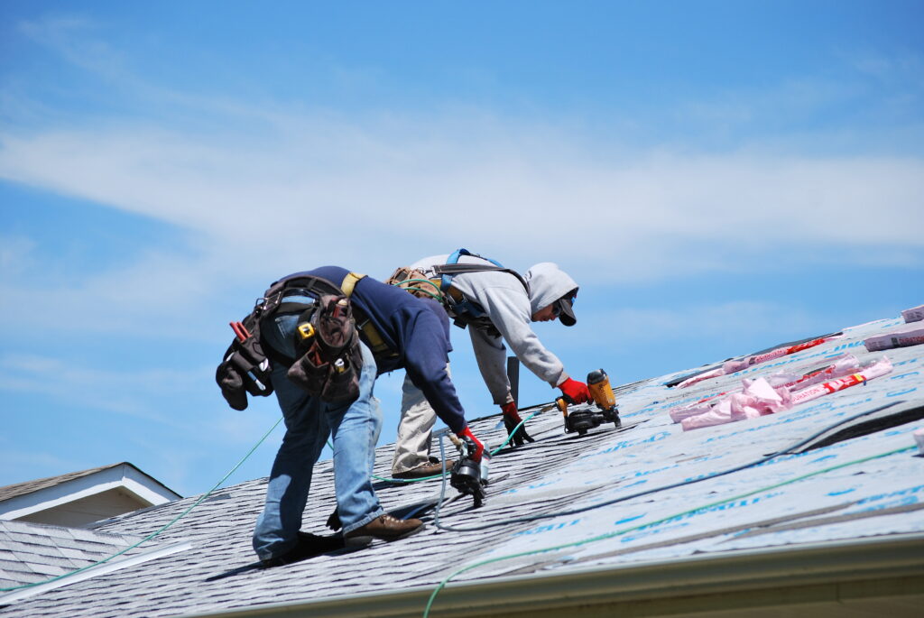 Roofing contractors in NJ working on a south jersey roof. Using a nailgun on a roof.