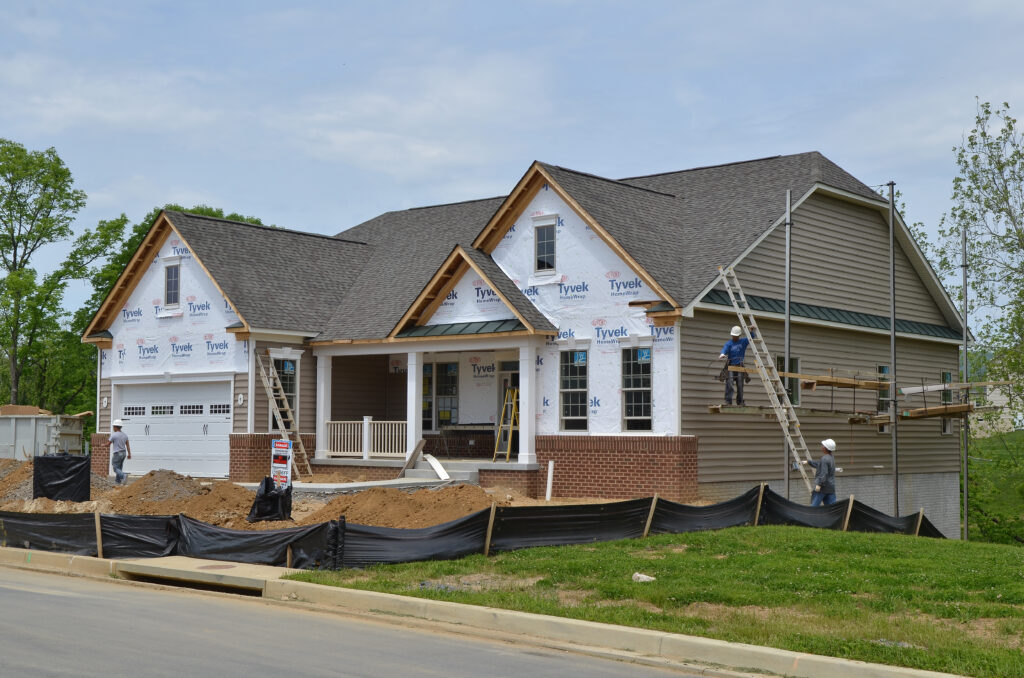 It is a photo of siding contractors in NJ working on a project.